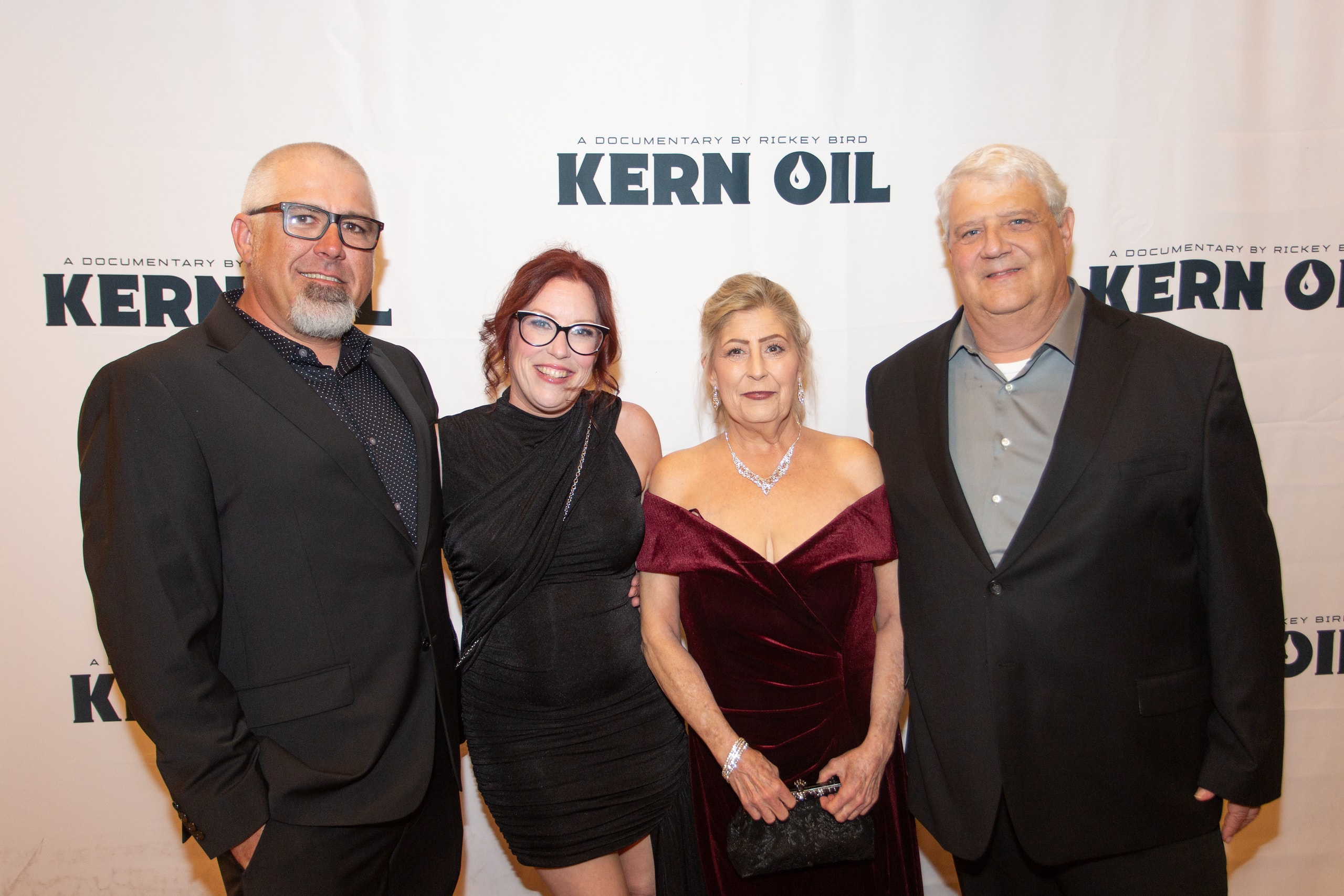 Four people posing at Kern Oil documentary premiere