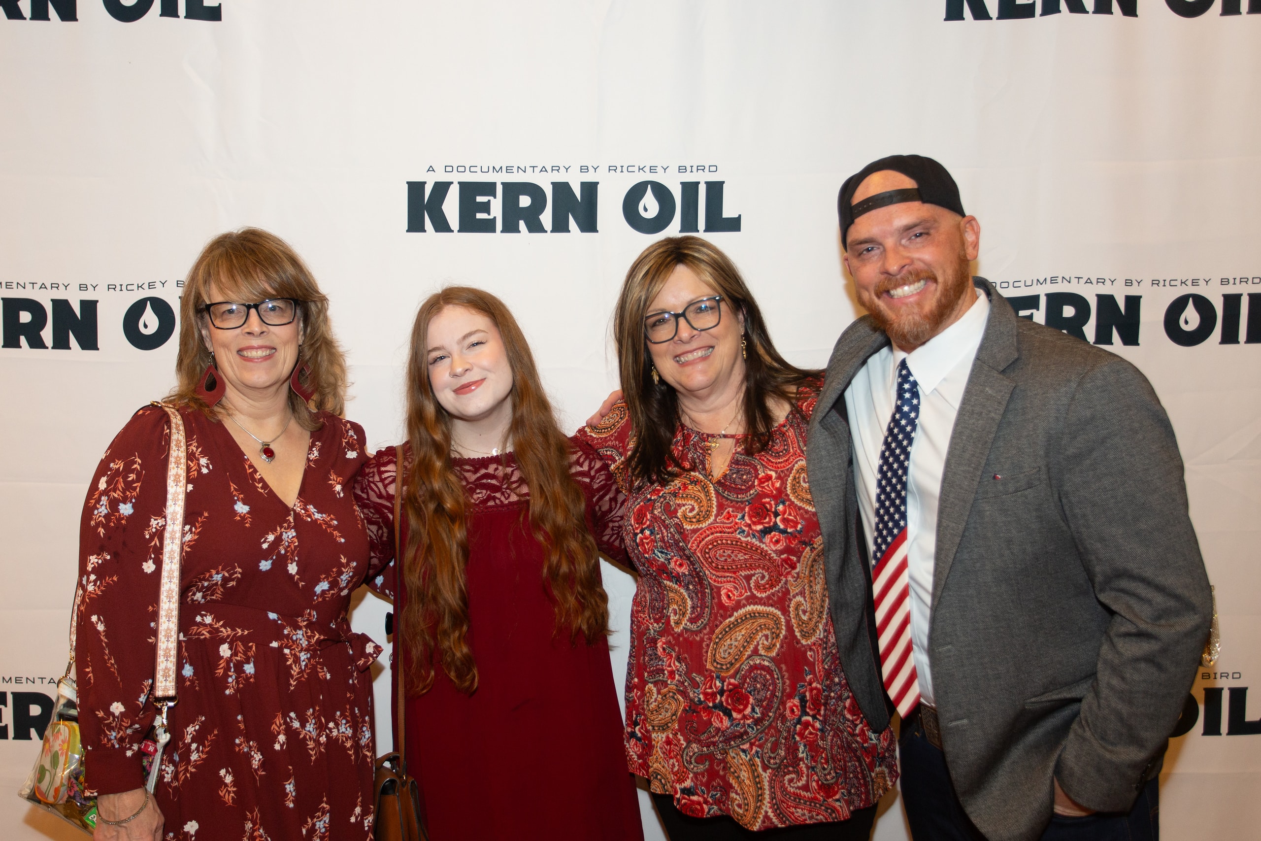 Four people posing at Kern Oil documentary premiere
