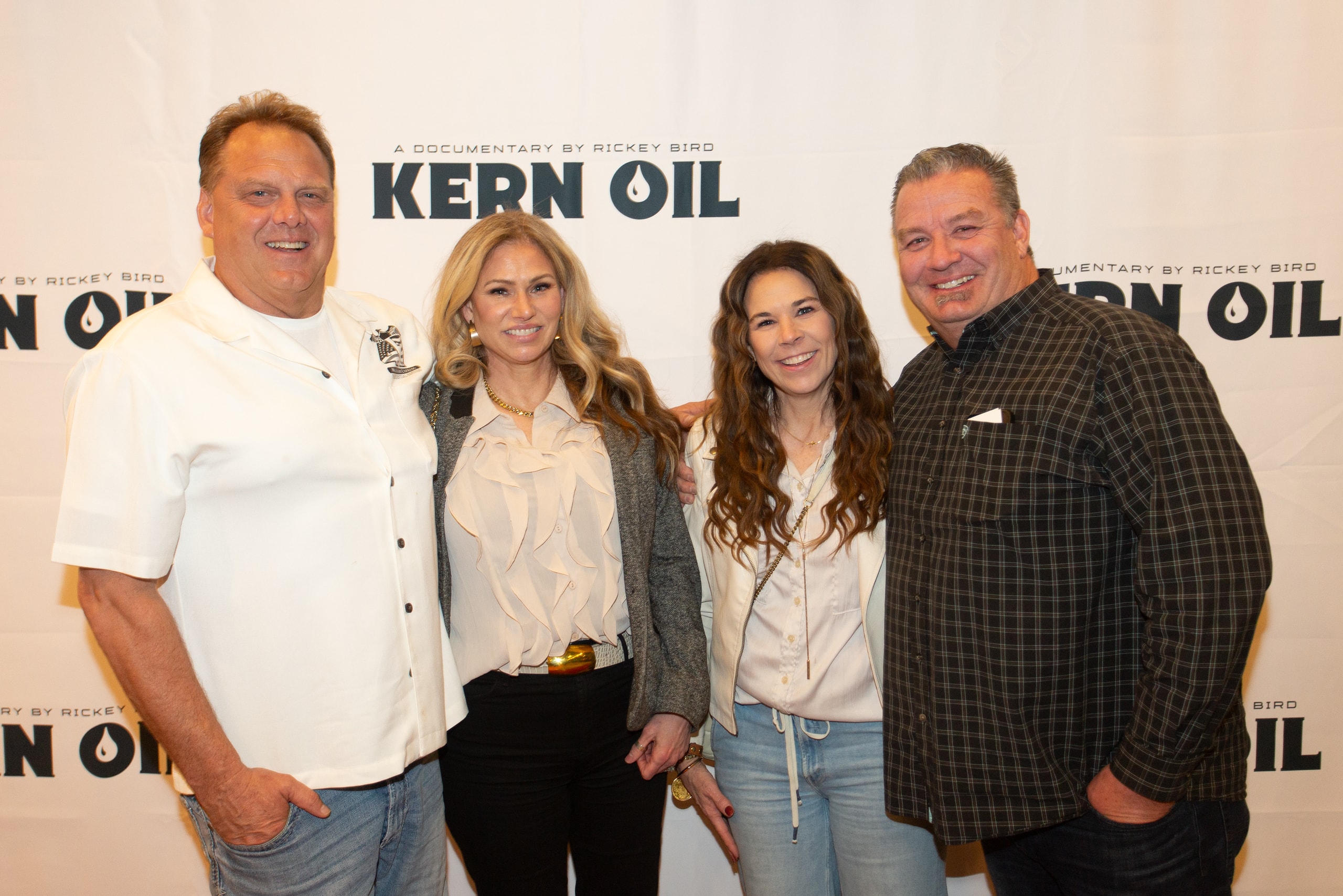 Four people posing at Kern Oil documentary premiere