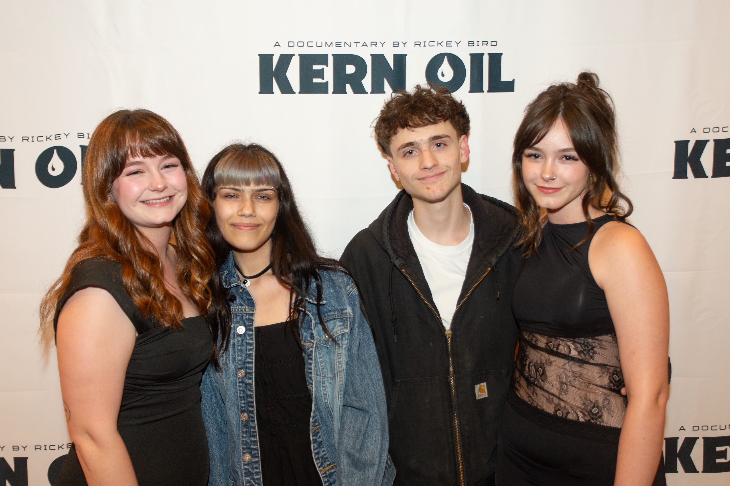 Four people posing at Kern Oil documentary premiere