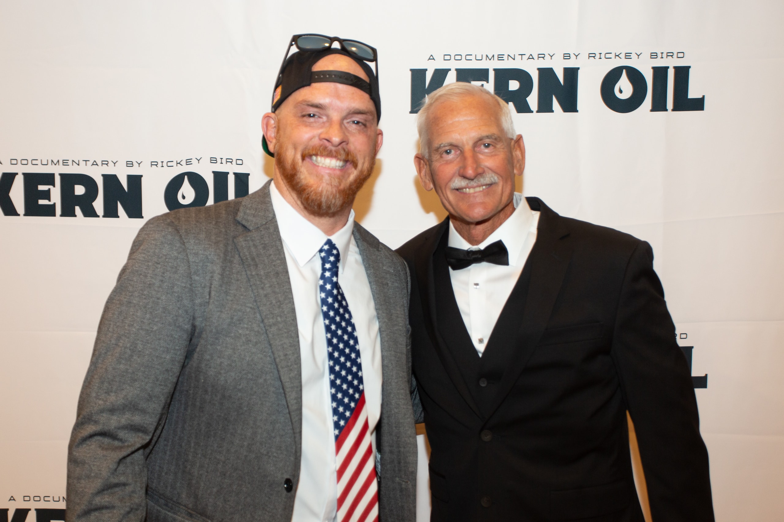 Two men posing at Kern Oil documentary premiere