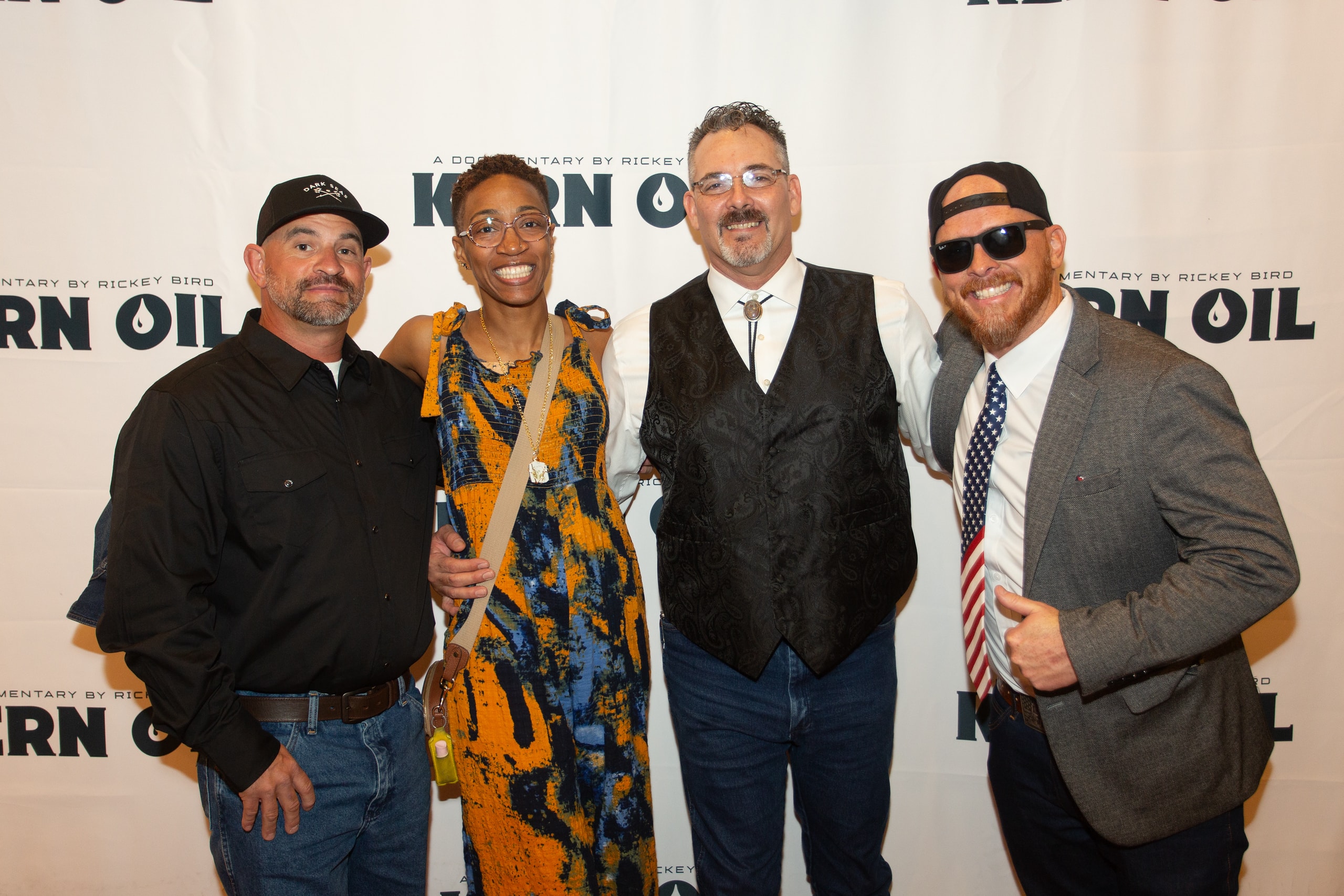 Four people posing at Kern Oil documentary premiere