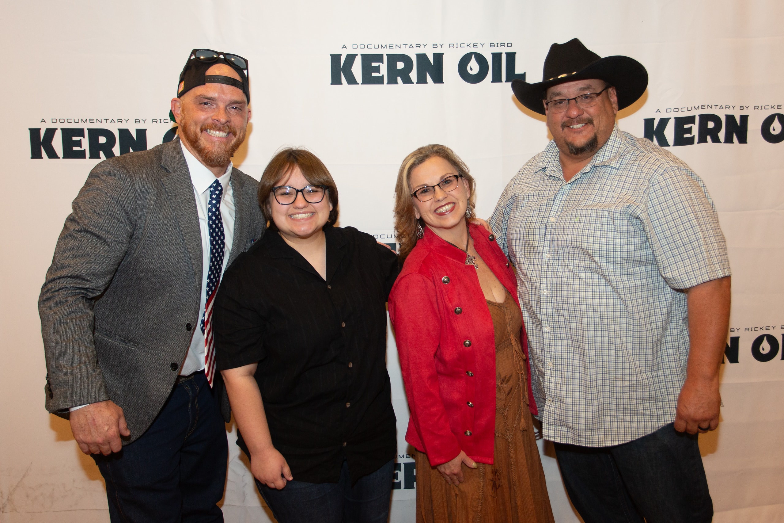 Four people posing at Kern Oil documentary premiere