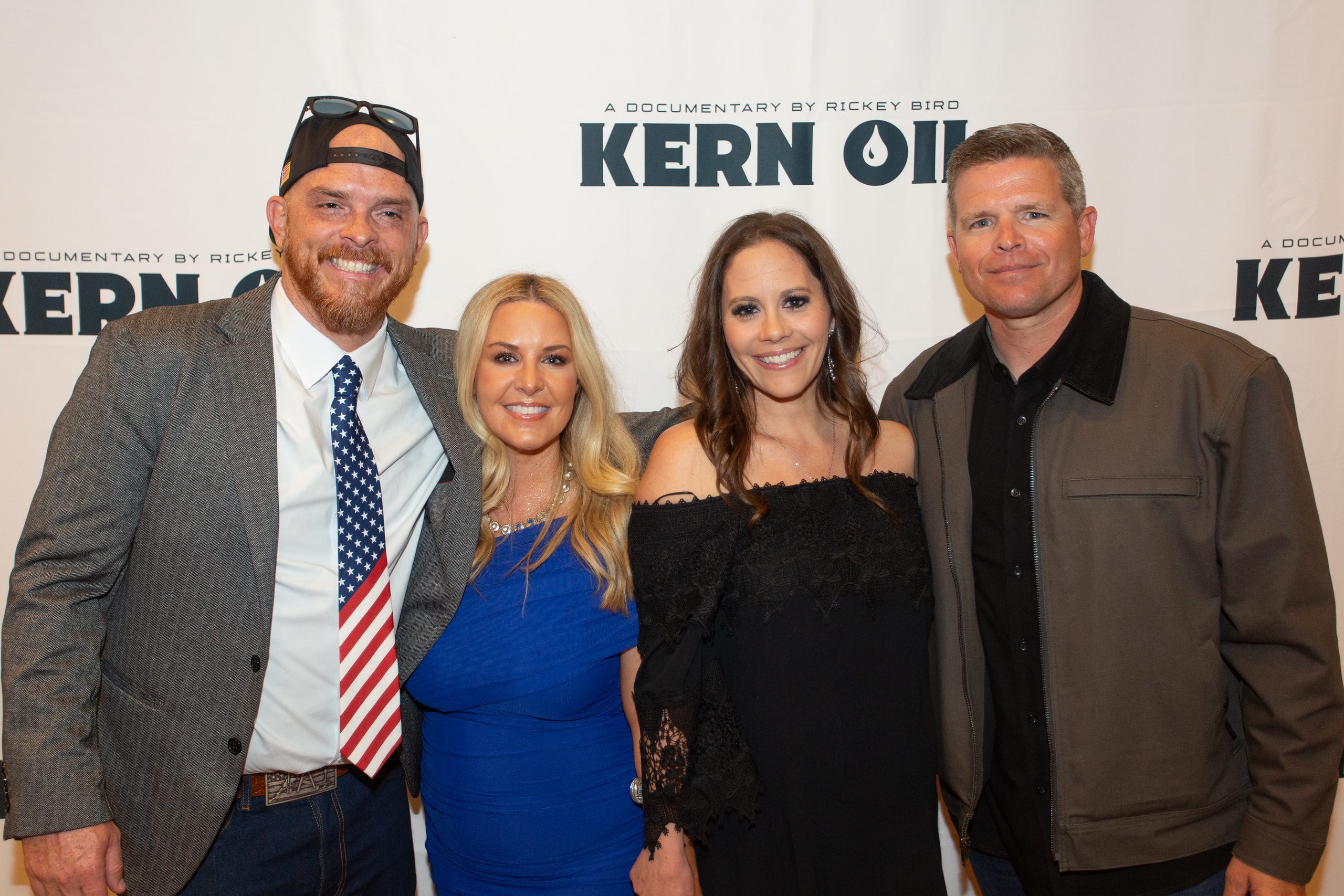 Four people posing at Kern Oil documentary premiere