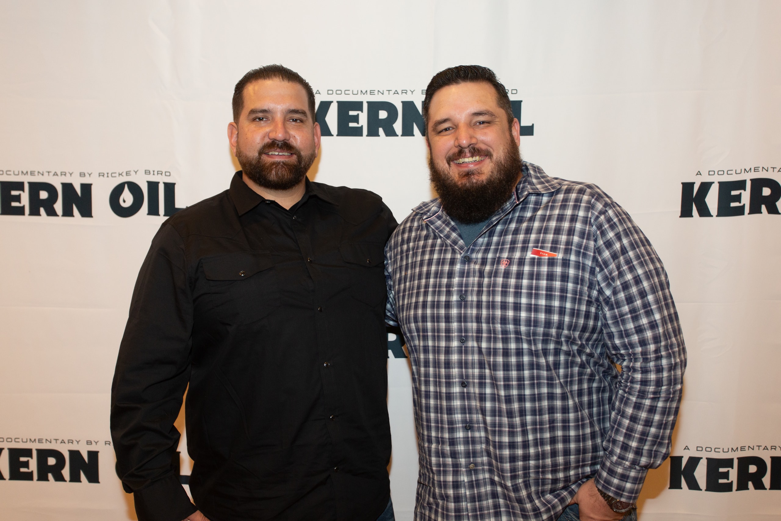 Two men posing at Kern Oil documentary premiere