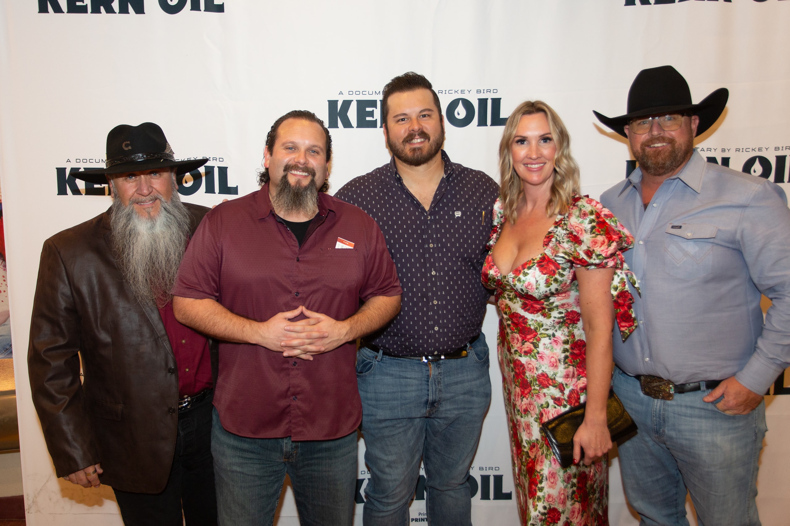 Five people posing at Kern Oil premiere